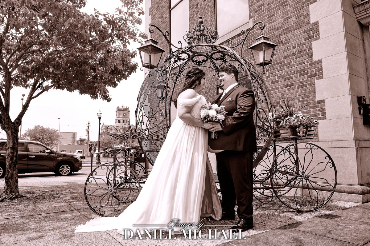 Natalie and Jared in front of carriage flower holder